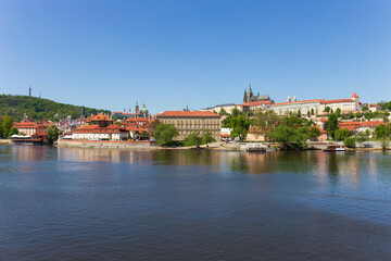 Fototapeta na wymiar Spring colorful Prague Lesser Town with gothic Castle above River Vltava in the sunny Day, Czech Republic