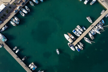 Fototapeta na wymiar Drone aerial scenery of a fishing port. Fishing boats and yachts moored in the harbour