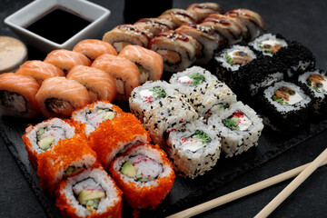 Delicious sushi platter with a variety of rolls and sauces