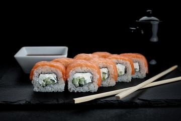 Delicious sushi roll with salmon, cream cheese, and cucumber