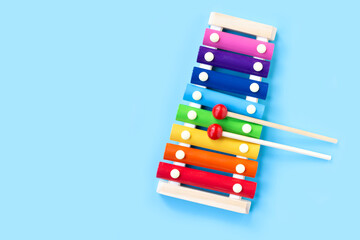 Colorful xylophone on blue background.