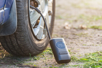 Inflating car tires with a portable wireless air pump outdoor