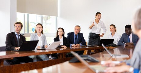 Business persons discussing work plan in meeting room. Managers and directors of company having conversation in conference room.