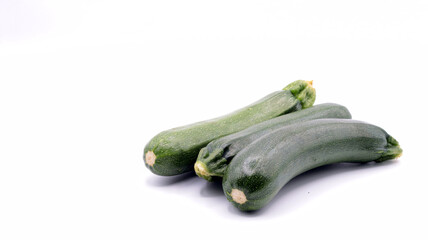 close up of a group of beautiful zucchinis on a white background