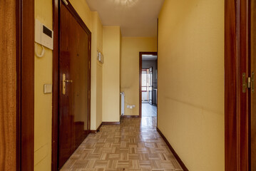 Hall of a residential house with parquet floors, armored access door
