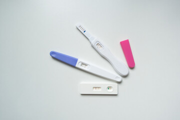 Planning pregnancy, health care concept. Positive pregnancy test isolated on white background, top view copy space.