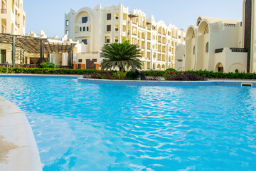 Rich luxury modern residential apartment hotel, tropical resort, swimming pool with blue clear...