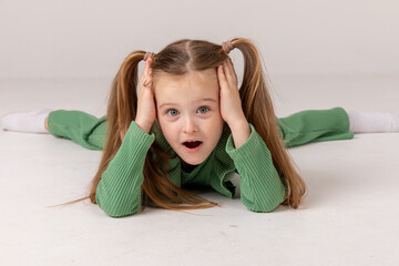 Portrait of little excited shocked crazy smiling girl child kid hold hands isolated on white...