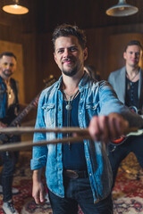 Young musicians practising the song in rehearsal room. High quality photo