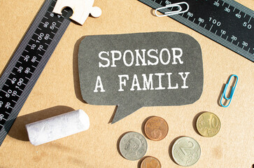 Sponsor A Family text written on a notebook with pencils.