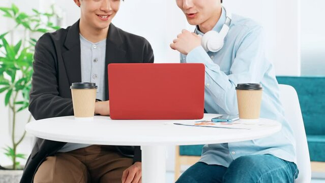 Young casual men group looking at laptop PC together. Video editor. Desk top music. DTM.