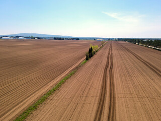 Fototapeta na wymiar Aerial view of agricultural fields in spring during sowing