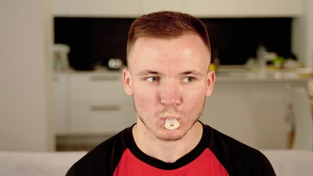 Bearded guy takes pacifier in mouth for fun and falls asleep