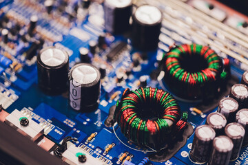 Closeup on electronic board in hardware repair shop, blurred and toned image. Shallow DOF, focus on...