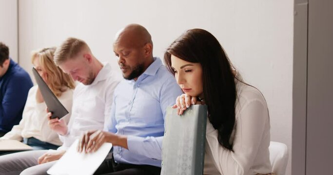 People Bored While Sitting On Chair Waiting For Job Interview