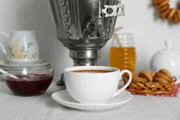 Composition with delicious ring shaped Sushki (dry bagels) and tea on white table