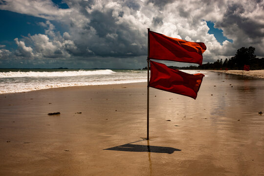 Red flags at the beach in Bintan due to rough waves and storms