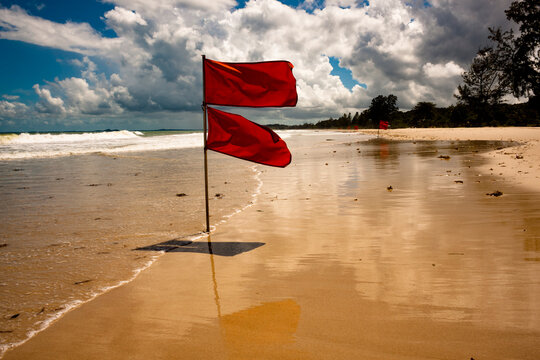 Red flags at the beach in Bintan due to rough waves and storms