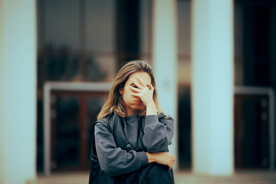 Unhappy Woman Making Facepalm Gesture Waiting Outside. Stressed person having a breakdown regret crisis
