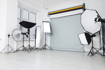 Interior of modern photo studio with professional lighting equipment