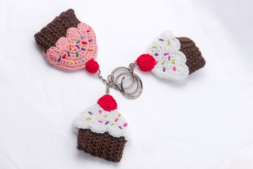 Obraz na płótnie Canvas Crocheted keychains in the shape of cupcakes of various flavors