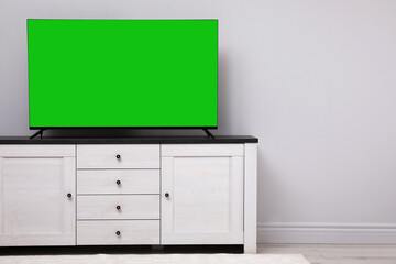 Chroma key compositing. TV with mockup green screen in room. Mockup for design