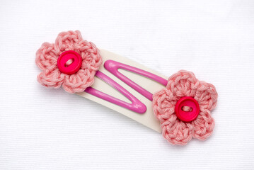 A pair of clasp woven flower hair clips