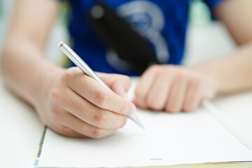Naklejka premium Asian teenage student write homework, study lesson for exam online learning education.