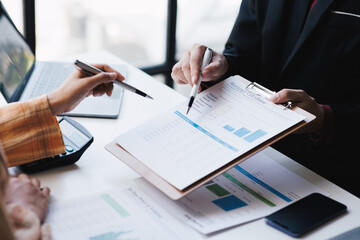 Cropped shot of professional business team working and discussing their recent financial project in...