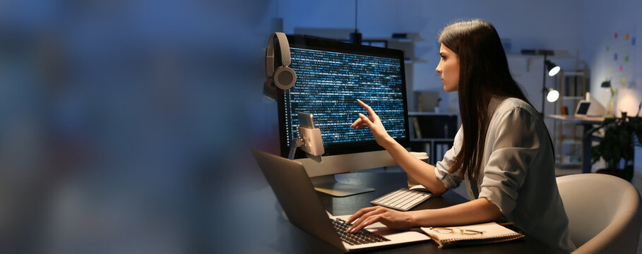 Female programmer working in office at night. Banner for design