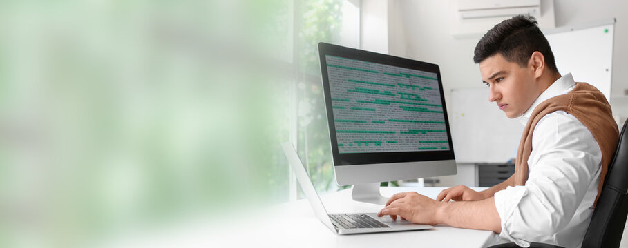 Male programmer working in office. Banner for design