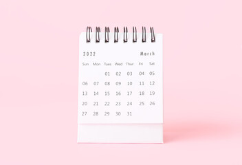 Flip paper calendar for March on pink background
