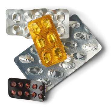 different kind of used empty pill blister packs, close-up of discarded silver medicine packs made of plastic aluminum foil and not biodegradable, isolated, disposal and recycling concept