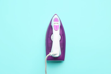 Electric iron on mint background