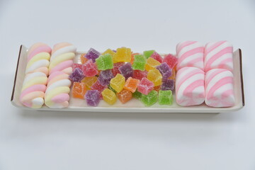 twist marshmallows pastel colors with skewer and multicolored  fruity candied