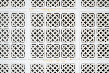 Close-up of an old white wall with an Islamic pattern.