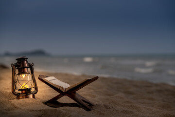 Ramadan Kareem with the Holy Quran. The Koran on the beach is cool and peaceful. - obrazy, fototapety, plakaty