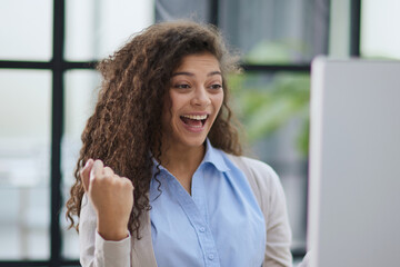 Emotional girl surprised with getting victory in online contest reading news from laptop computer