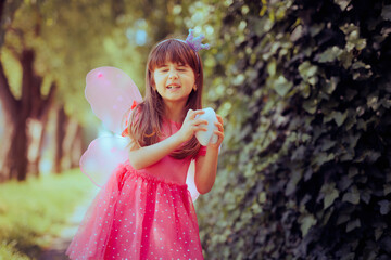 Little Girl in Tooth Fairy Costume Holding a Molar Toy. Cute, adorable child promoting proper...