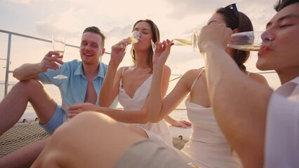 Group of diverse friends drink champagne while having a party in yacht.