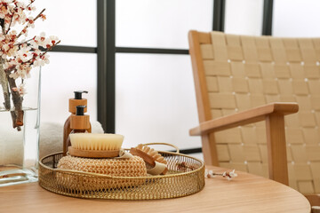 Tray with bath accessories on table in room, closeup