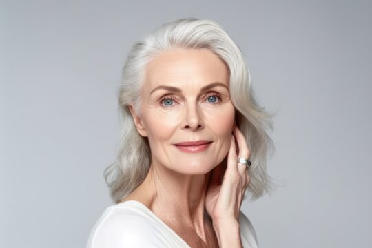 Beautiful gorgeous 50s mid aged mature woman looking at camera isolated on white. Mature old lady close up portrait. Healthy face skin care beauty, middle age skincare cosmetics. Generative AI