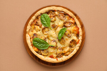 Mushroom pie with spinach leaves on brown background