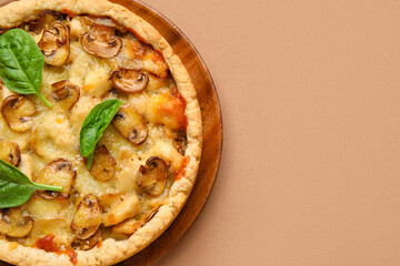 Mushroom pie with spinach leaves on brown background