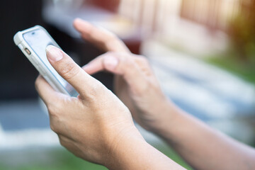 People, technology, job, occupation and age. Close up shot of senior woman hands holding smart phone.