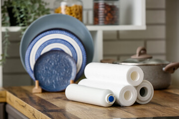 Water filters on wooden table in kitchen