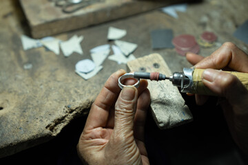 Close-up of craftsman hand making ring made of silver Folk handicrafts of Nan Province, Thailand