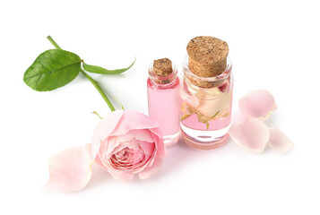 Obraz na płótnie Canvas Bottles of cosmetic oil with rose extract and flower on white background