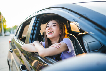 Young beautiful asian women getting new car. she very happy and excited. Smiling female driving...