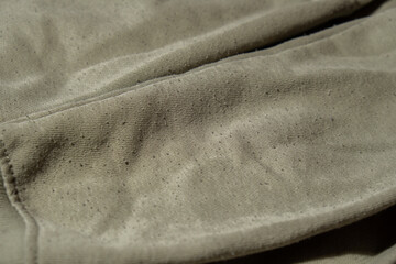 Lints on green sweater. Before cleaning and collected fluff lint. Closeup Pilled Clothes. Old used...